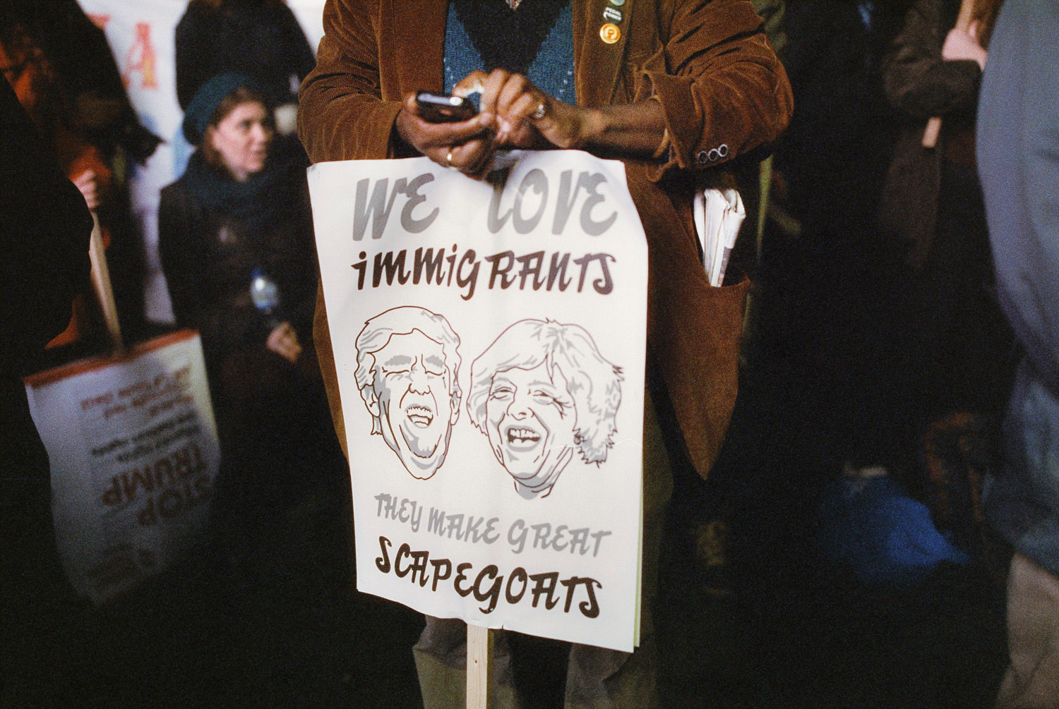 sign at march against Trump state visit