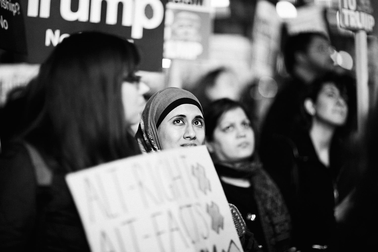 Muslim woman looking up at the march against Trump in London