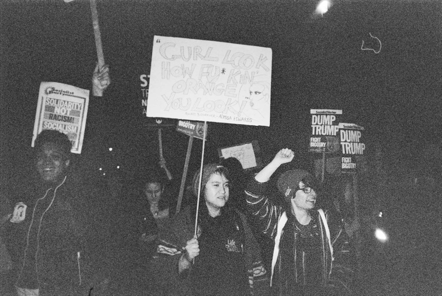 people holding placards at reading "Dump Trump" in Westminster