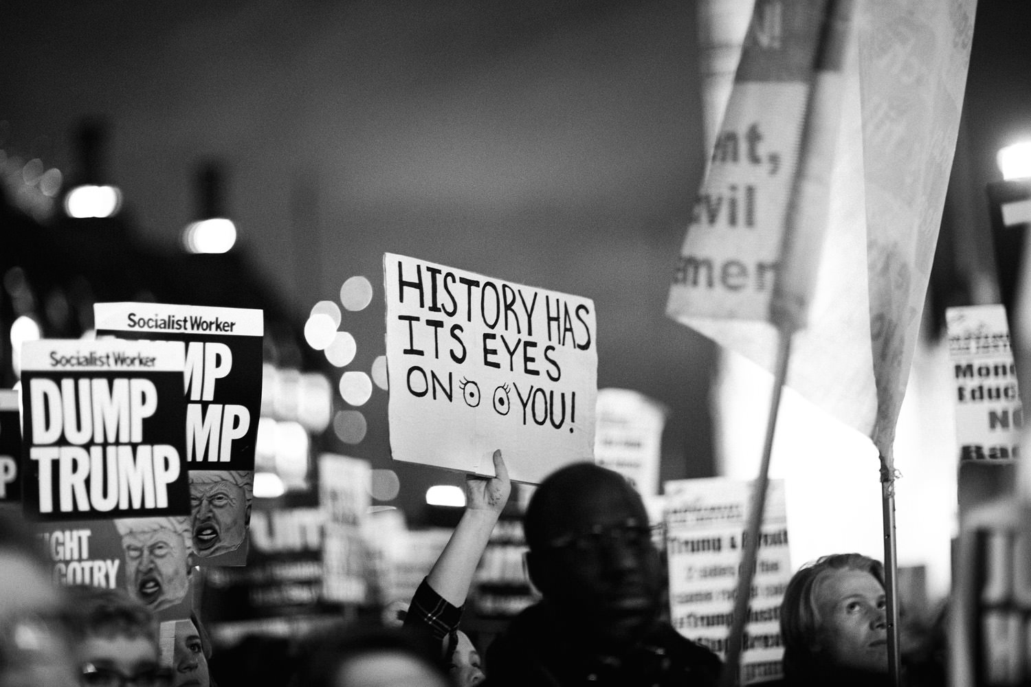 lots of placards held up at London march against Donald Trump
