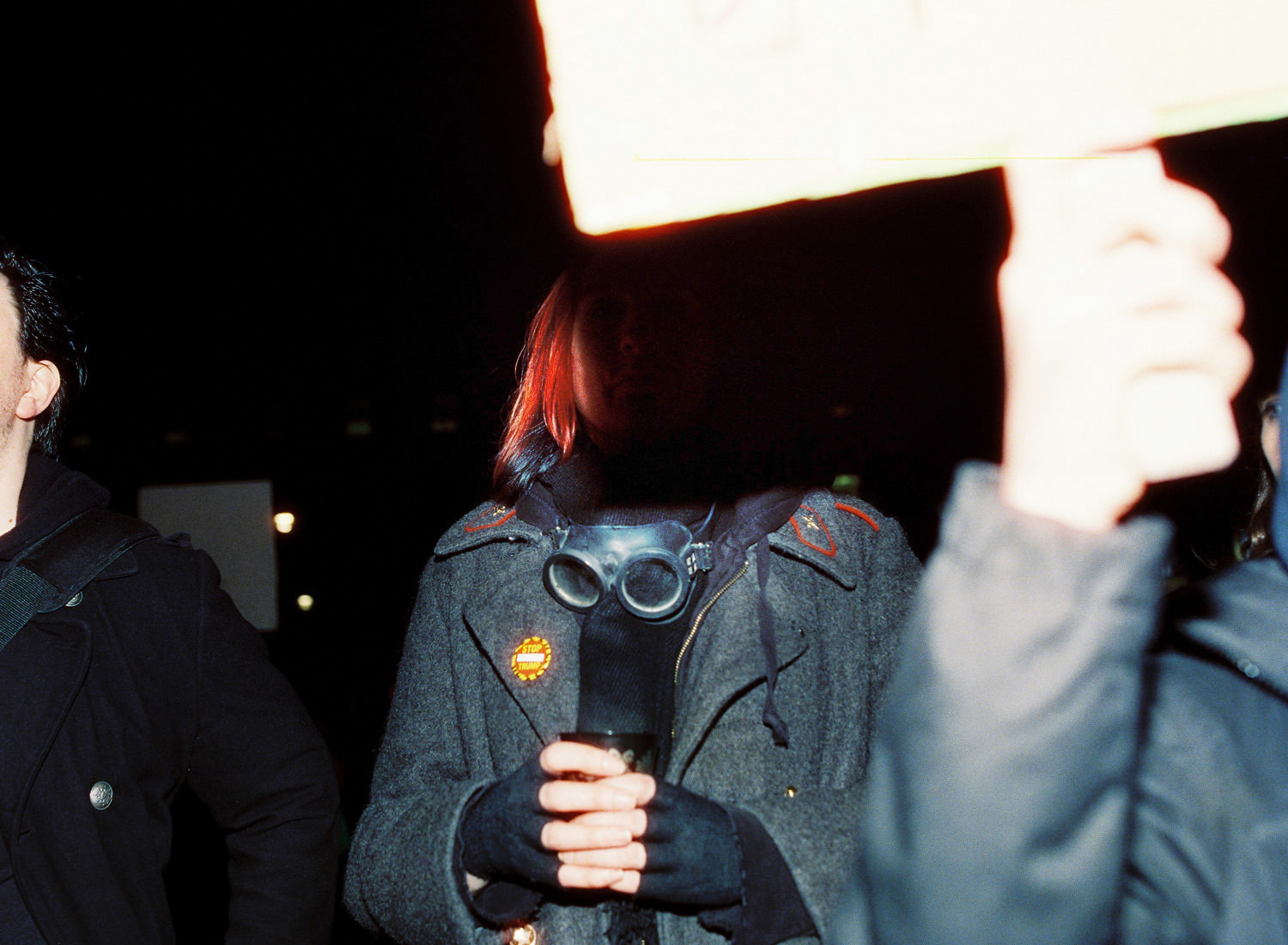man wearing vintage military coat with goggles around his neck