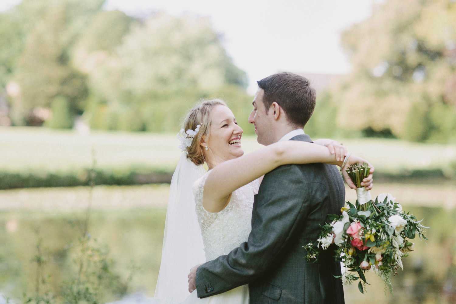 Bride and groom smile at somerset manor house wedding 
