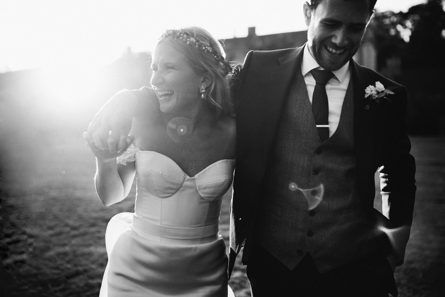 bride wearing hermione de Paula wedding dress and a groom smile while walking