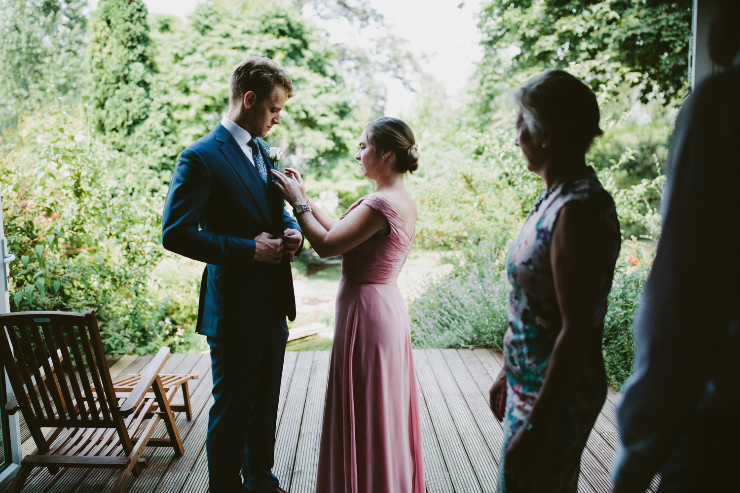 groom getting ready with a bridesmaid
