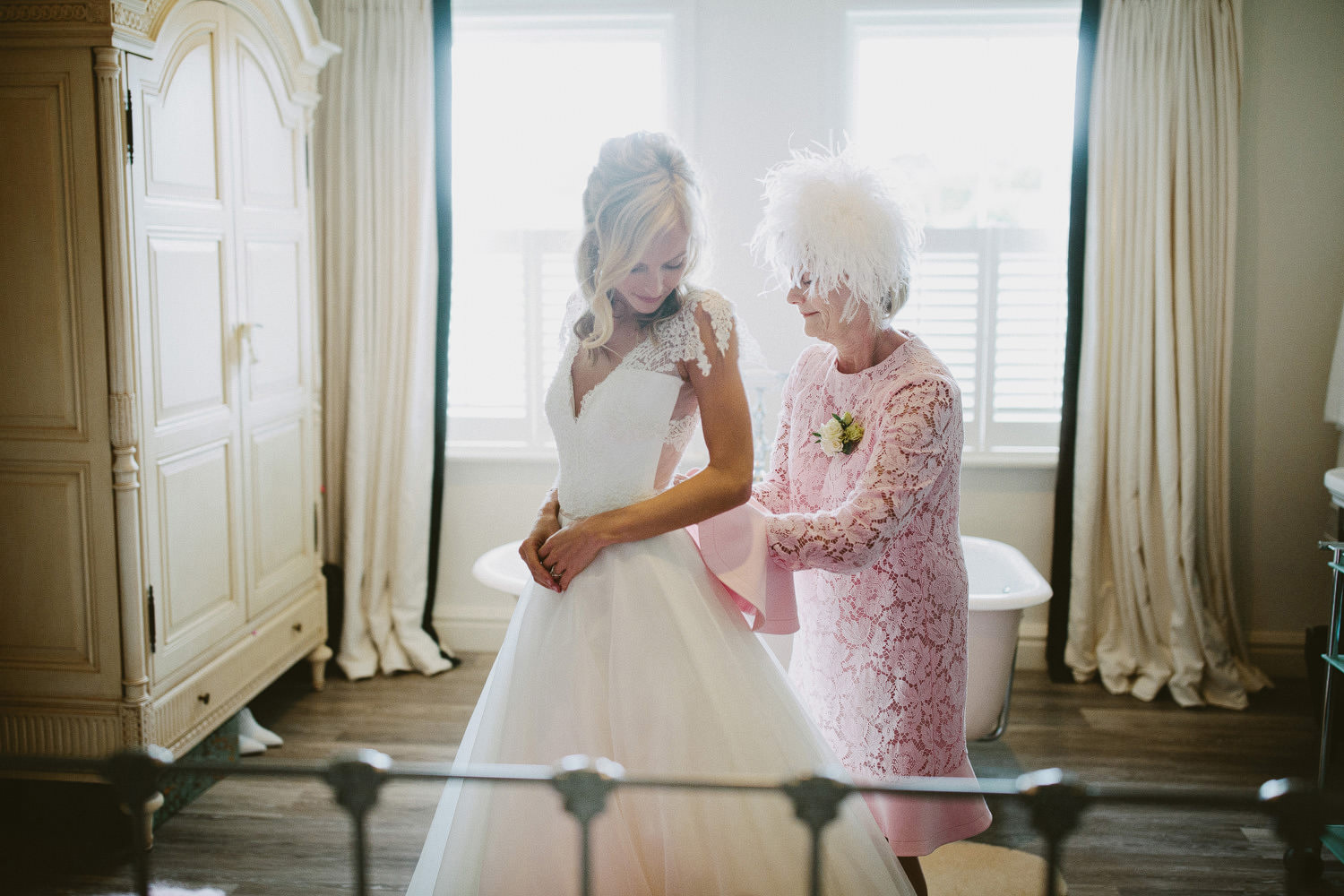 bride getting ready with mother helping for Oxford wedding