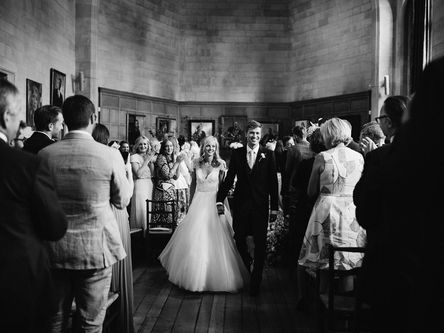 bride and groom leave ceremony at their Oxford wedding