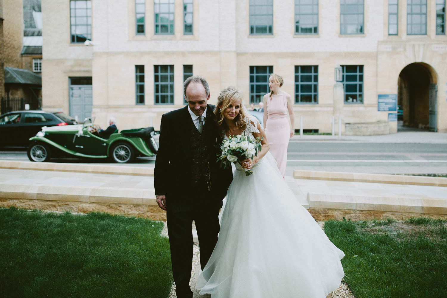 dad hugging bride at Oxford wedding