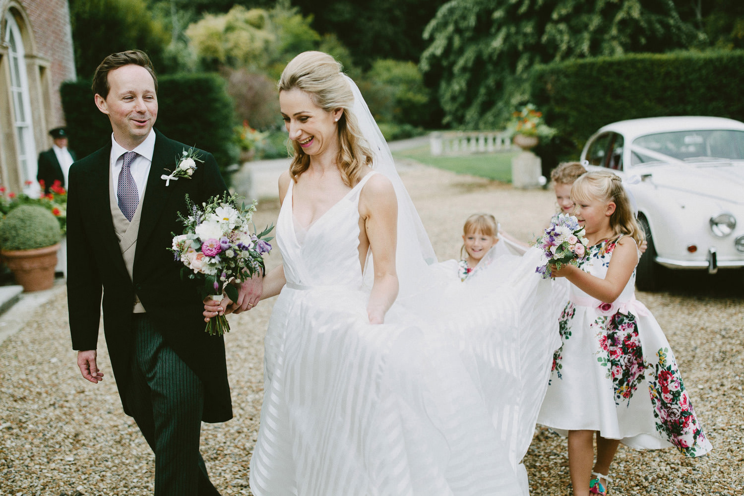 bridesmaids holding dress at Yarlington house in Somerset