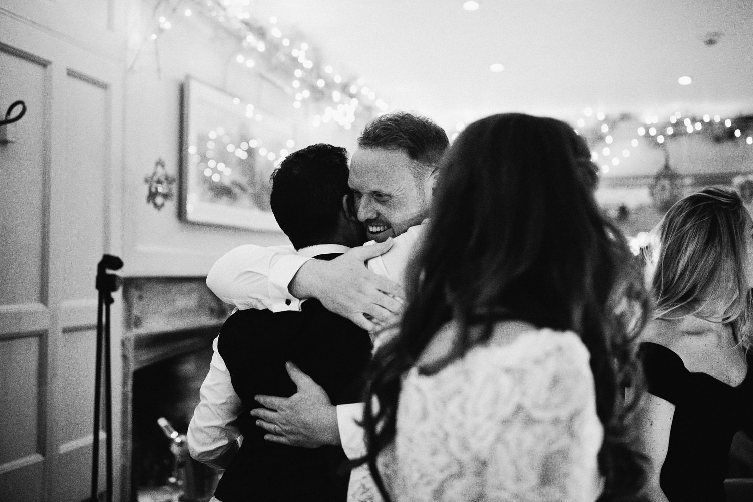 groom huggin best man at Barnsley house