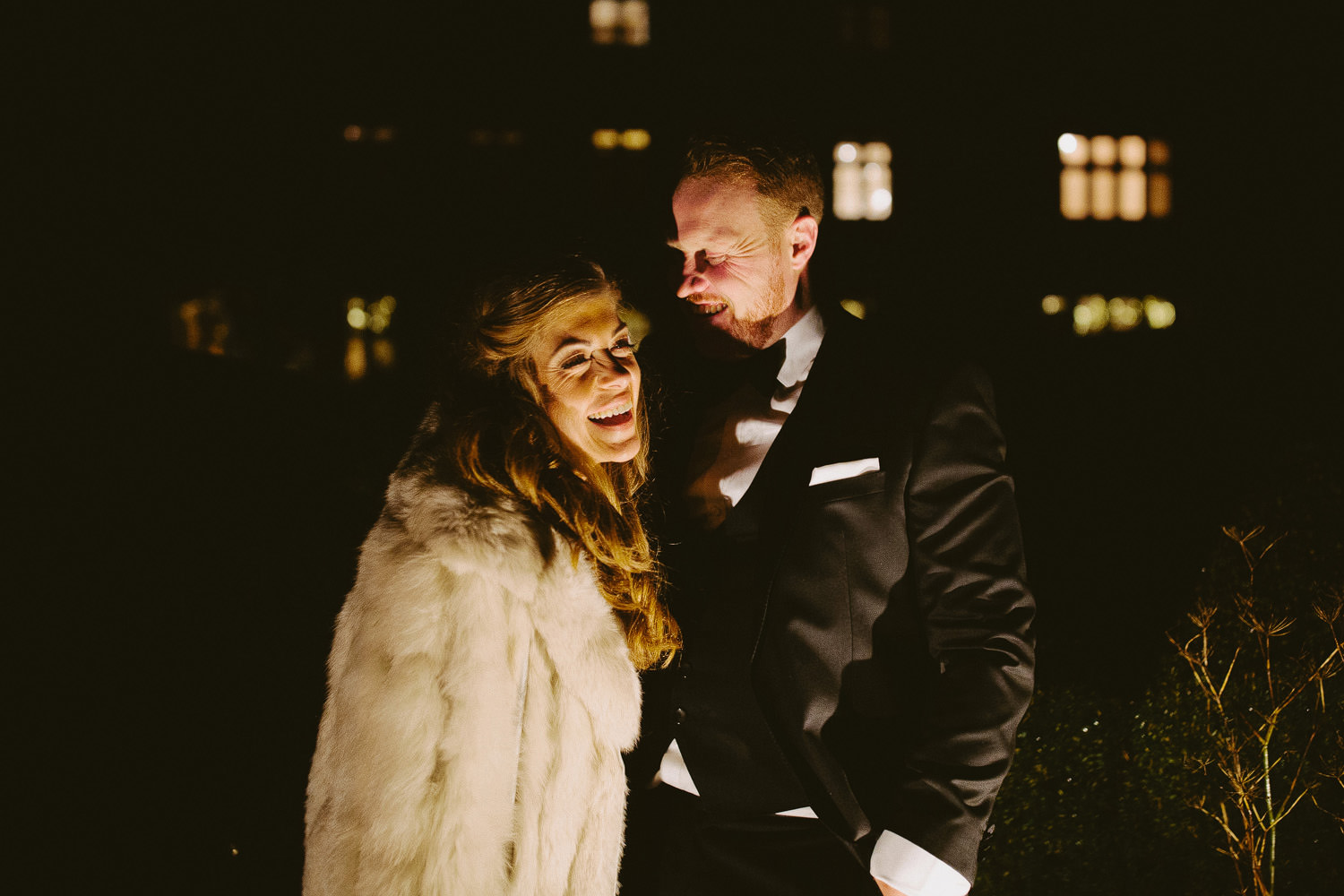 bride and groom outside Barnsley house at night time