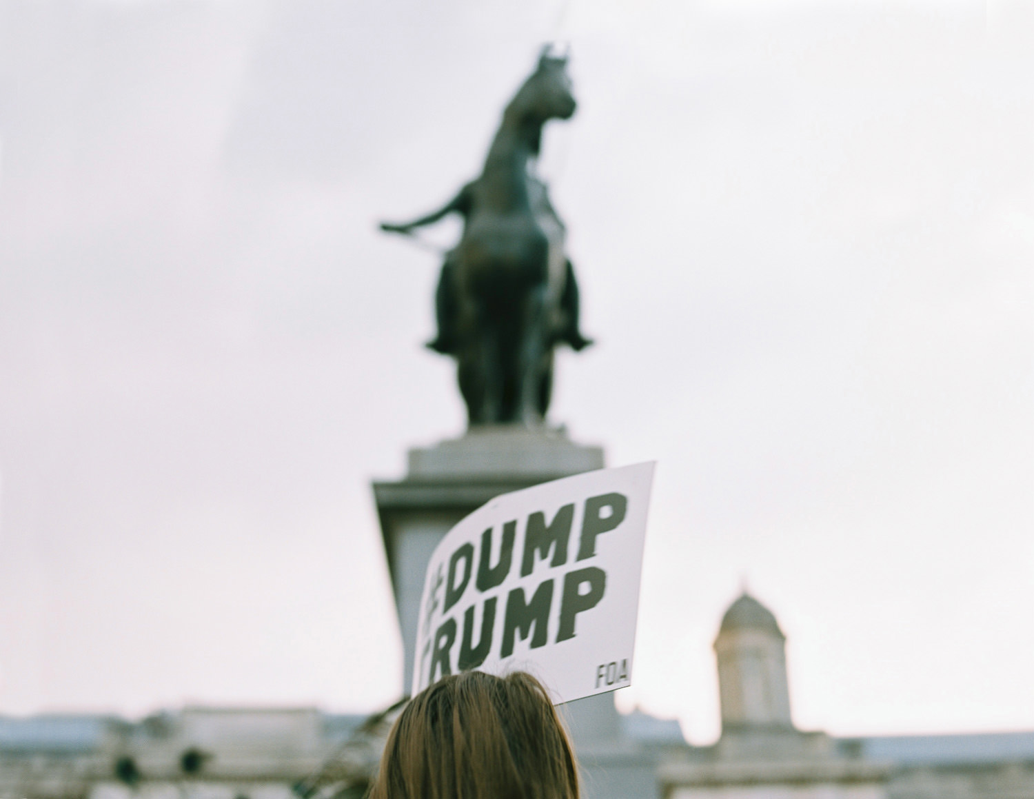 protestor in front of horse statue