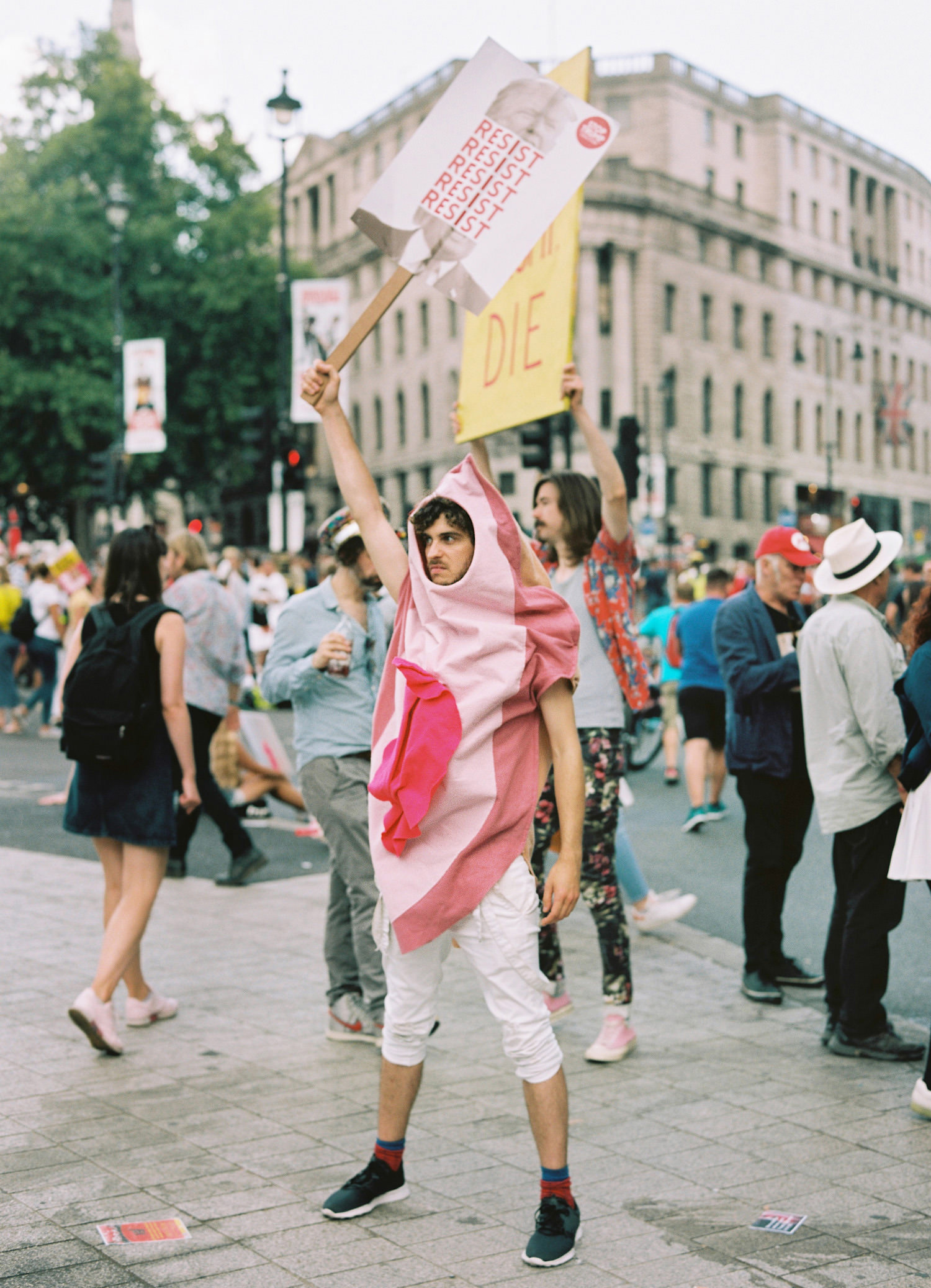 man dressed as vagina holding placard at London Trump demonstration