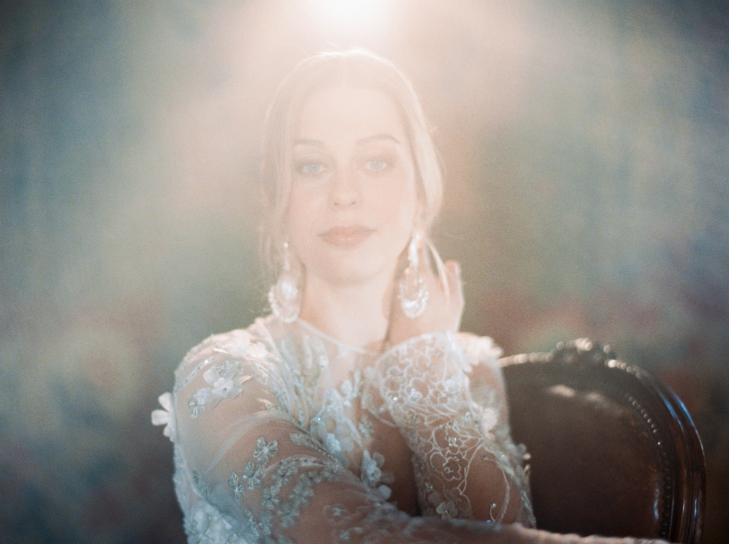 bride in naeem khan dress seated at Hilles House