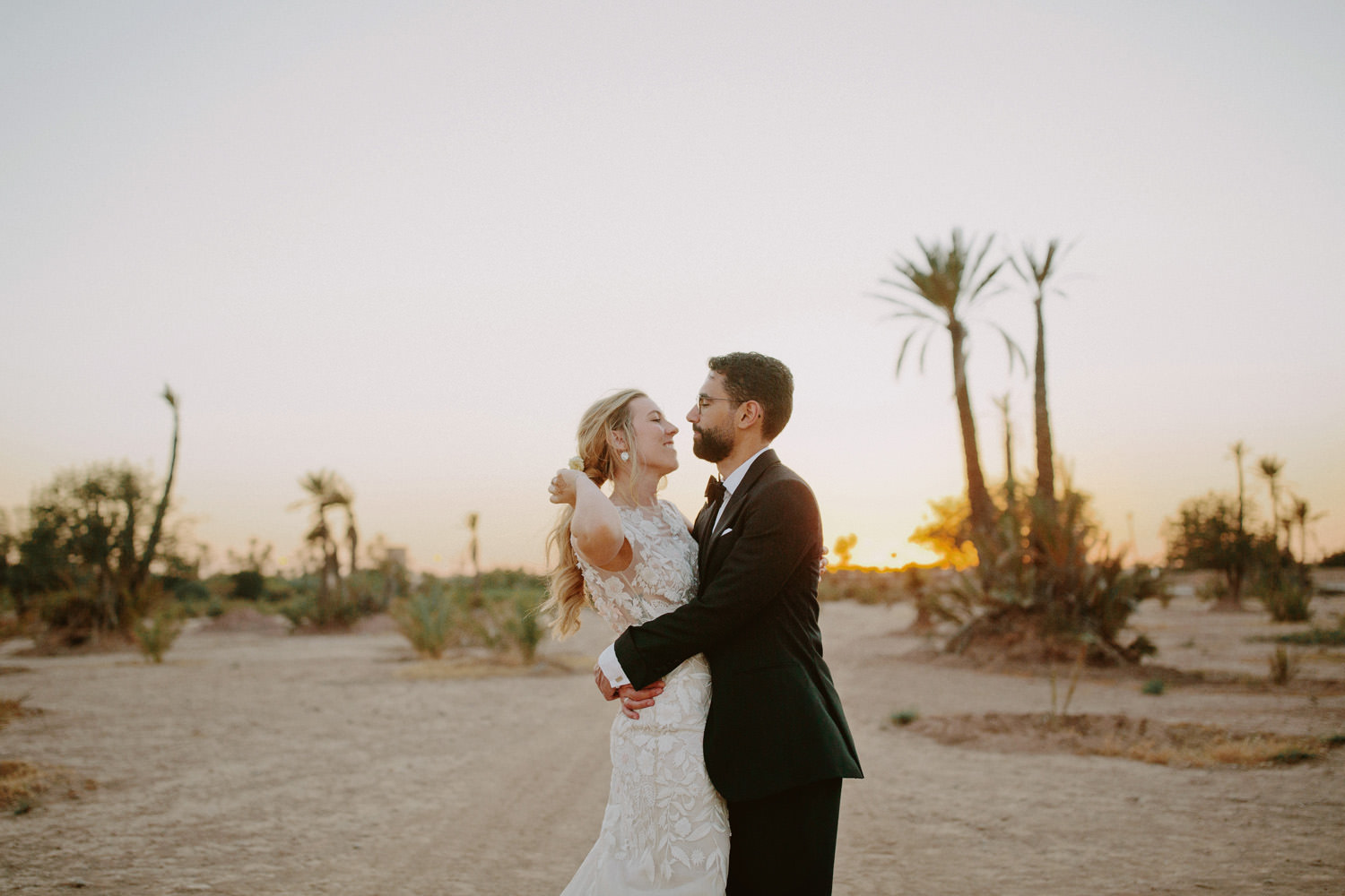 bride and groom face each other in the desert near Marrakech