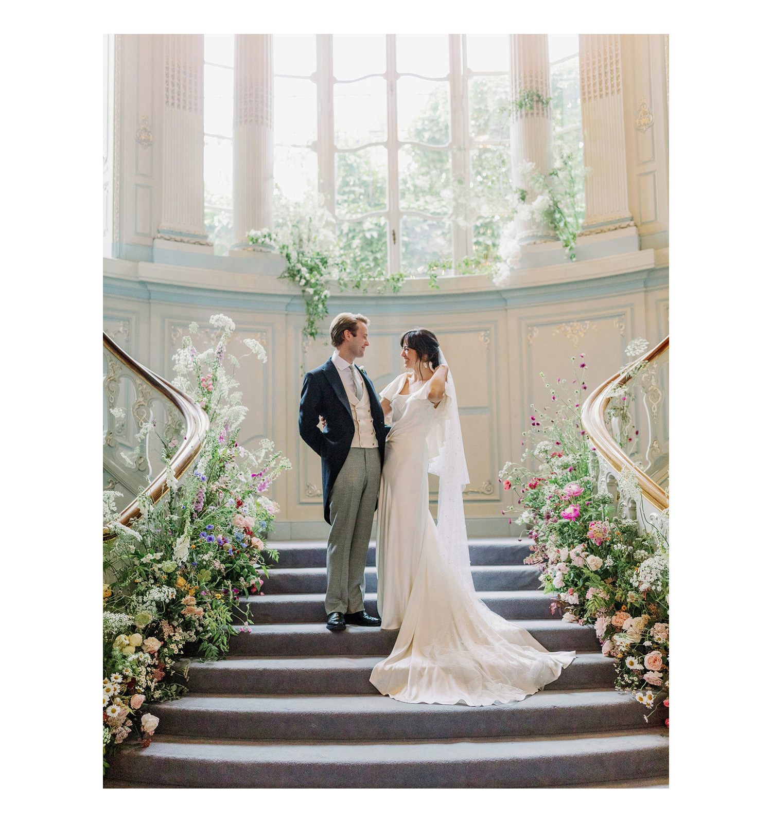 bride and groom on the staircase at the Savile Club in London